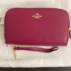 Brand new Coach double zip leather wallet, hand strap included. Color deep red.